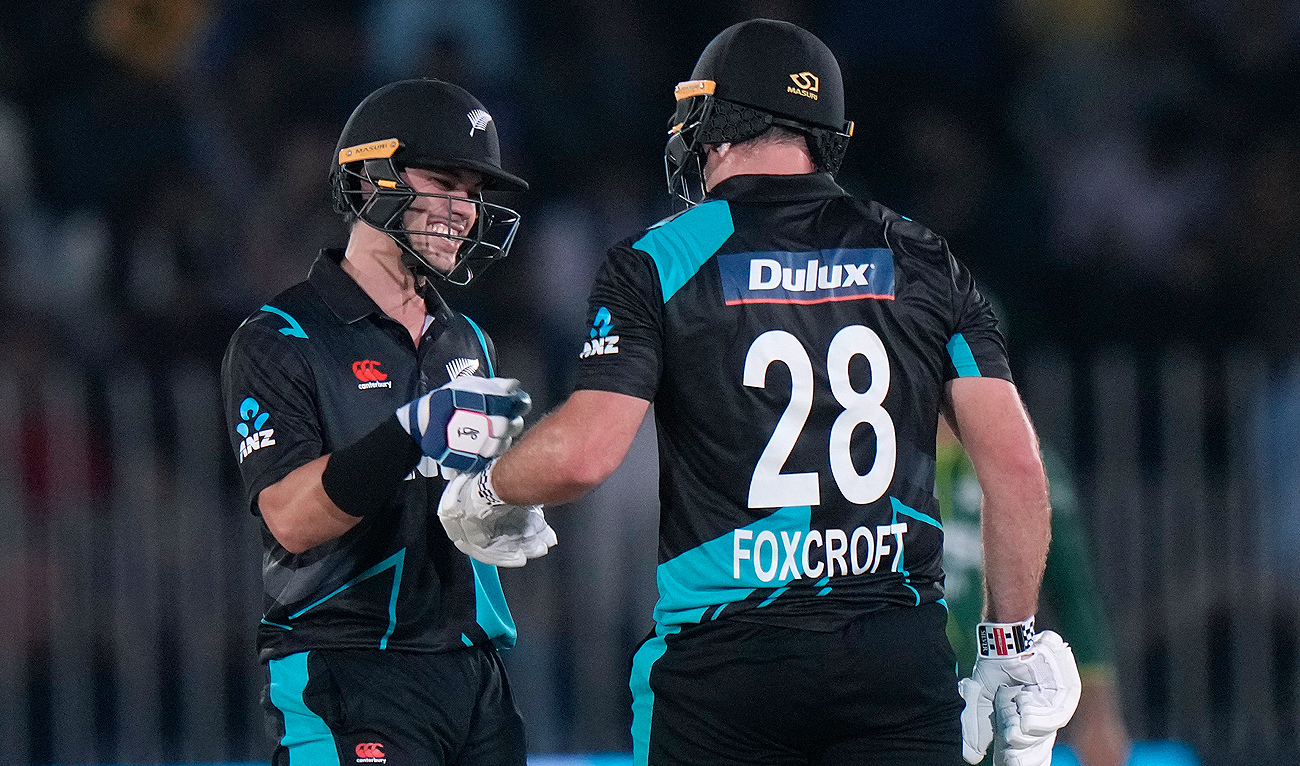 New Zealand's Mark Chapman, left, celebrates with Dean Foxcroft after hitting a boundary during the third T20 international cricket match between Pakistan and New Zealand, in Rawalpindi on April 21, 2024. (AP)