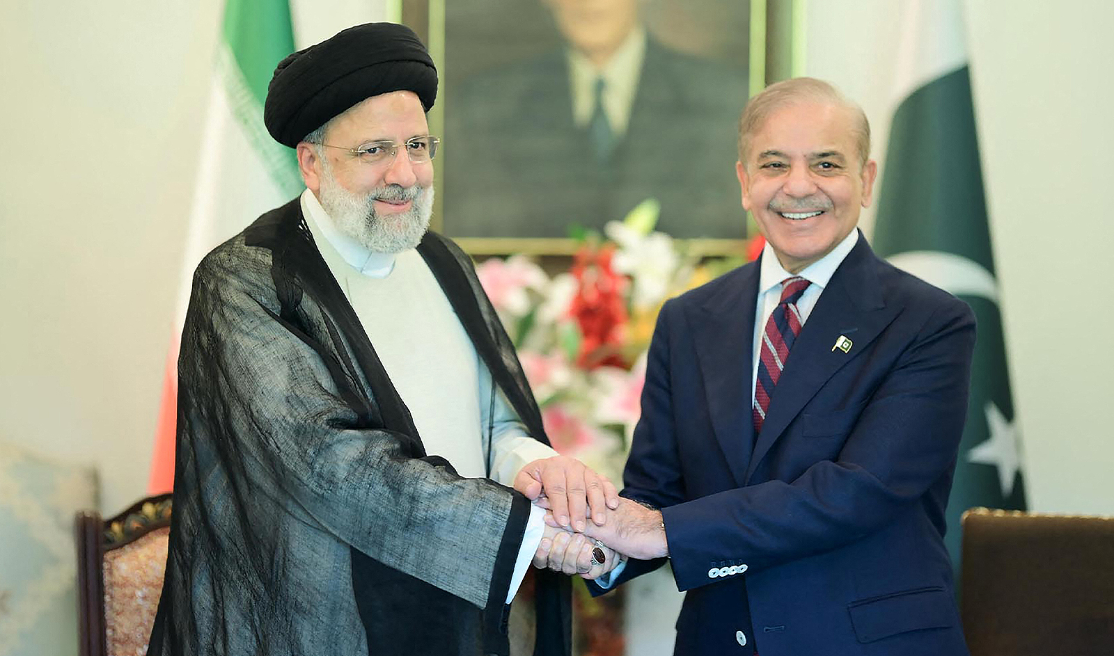 This handout photograph taken on April 22, 2024, and released by Pakistan's Press Information Department (PID) shows Iran’s President Ebrahim Raisi (L) shakes hands with Pakistan's Prime Minister Shehbaz Sharif upon his arrival at the Prime Minister House in Islamabad. (PID)