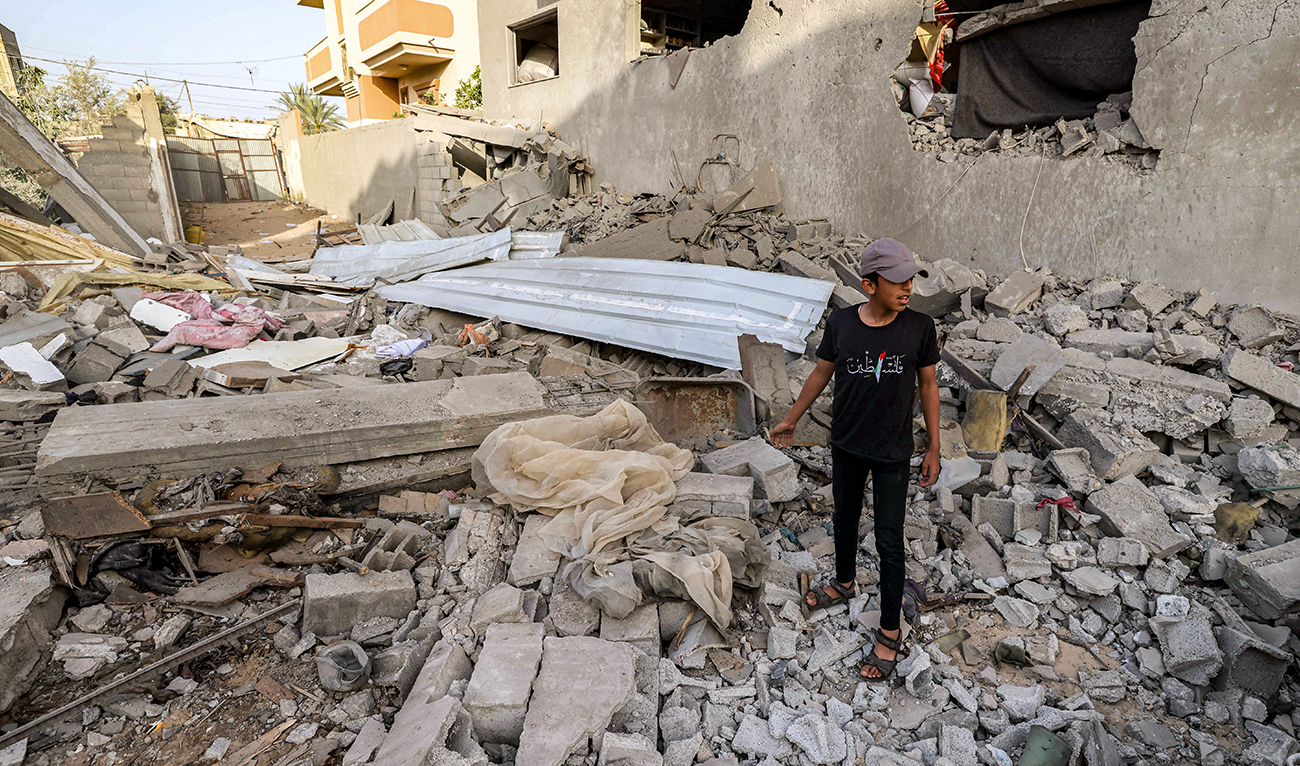 A boy stands amidst rubble in Rafah in the southern Gaza Strip on April 24, 2024 following reported Israeli air strikes overnight amid the ongoing conflict in the Palestinian territory. (AFP)