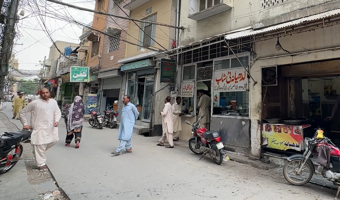 People walk past decades-old Ludhiana Tea Shop, named after an Indian state post partition, in Rawalpindi on April 23, 2024. (AN Photo)