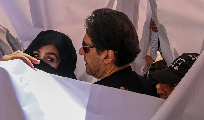 In this file photograph, taken on May 15, 2023, former Pakistan Prime Minister Imran Khan (C) with his wife Bushra Bibi (L) arrive to appear at a high court in Lahore. (AFP/File)