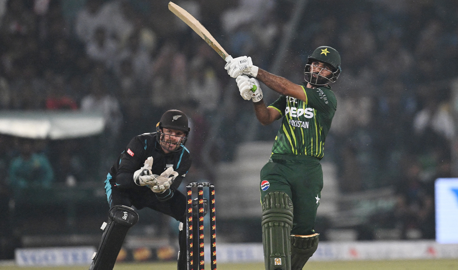 Pakistan's Fakhar Zaman (R) hits a six during the fourth Twenty20 international cricket match between Pakistan and New Zealand at the Gaddafi Cricket Stadium in Lahore on April 25, 2024. (AFP)