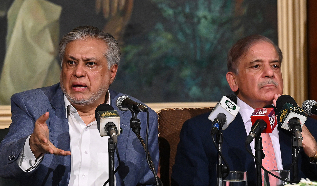 In this file photograph, taken on June 30, 2023, Pakistan’s Prime Minister Shehbaz Sharif (R) and the then finance minister, Ishaq Dar (L), address a press conference in Lahore. (AFP/File)