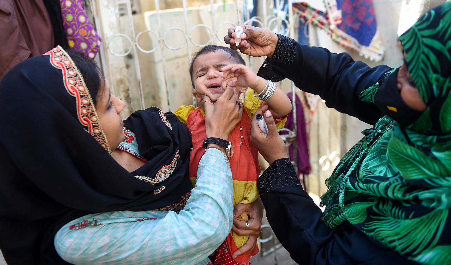 A health worker administers polio drops to a child during a door-to-door vaccination campaign in Karachi on October 2, 2023. (AFP/File)