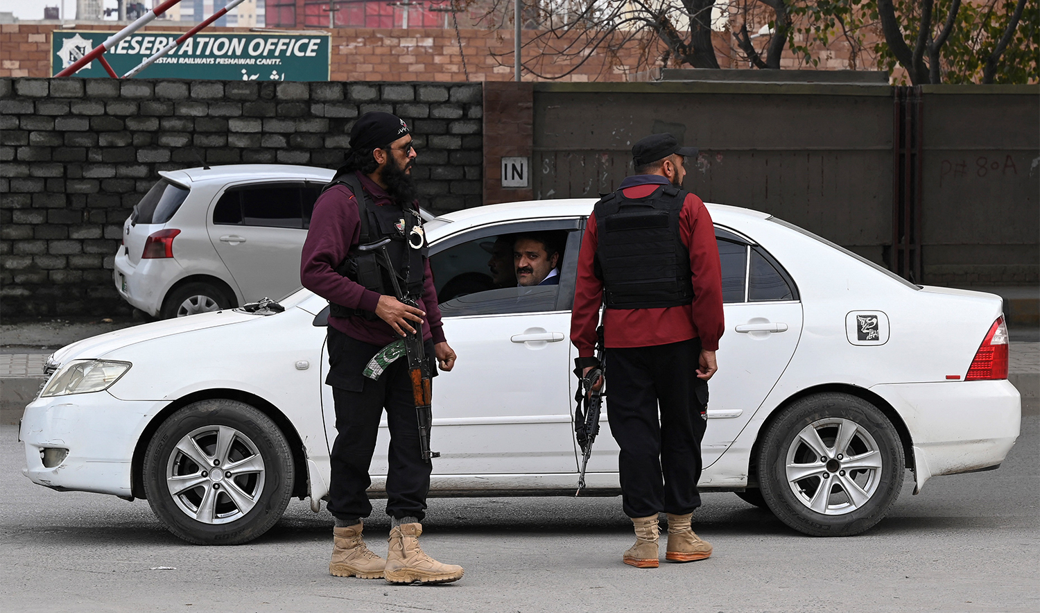 In this picture taken on February 1, 2023, policemen stand guard along a street in Peshawar. (AFP/File)