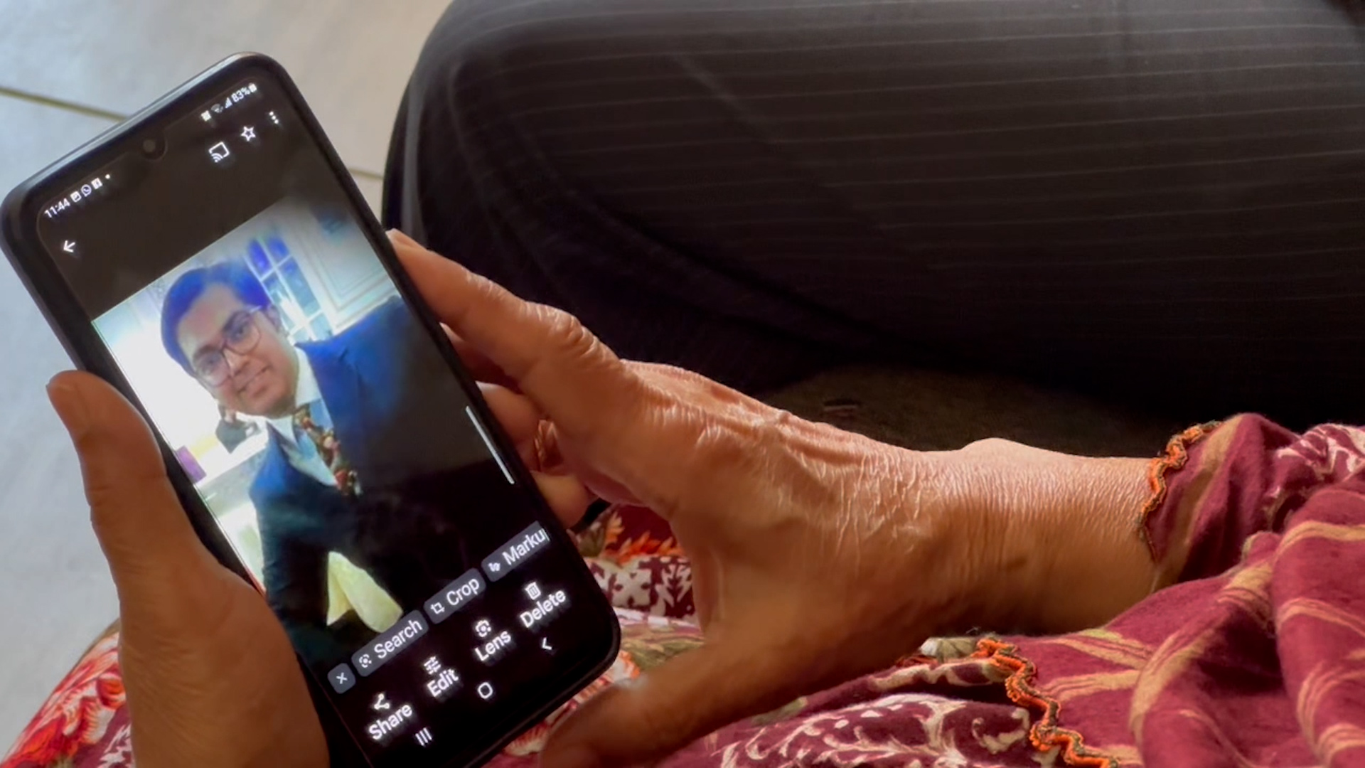 The photo taken on April 26, 2024, shows Syed Turrab Hussain Zahedy's photo displayed on his mother's mobile phone screen in Karachi, Pakistan. (AN Photo)