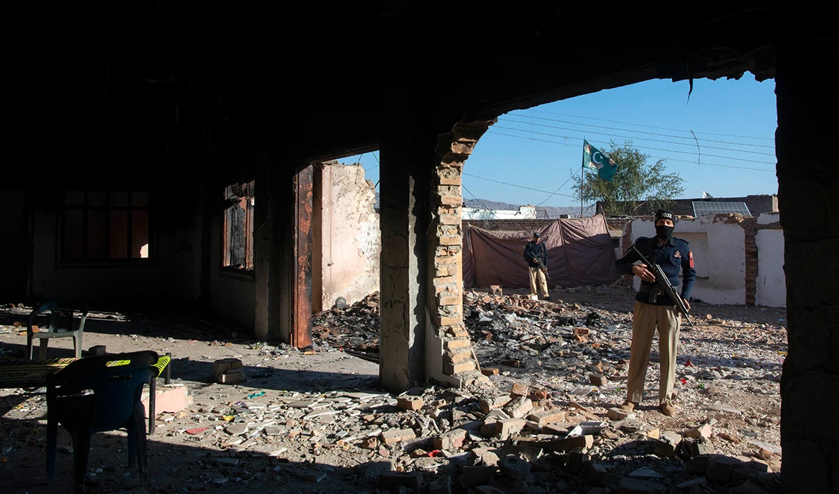 Policemen stand guard at the burnt Hindu temple a day after a mob attack in a remote village in Karak district, some 160 kms southeast of Peshawar on December 31, 2020. (AFP/File)