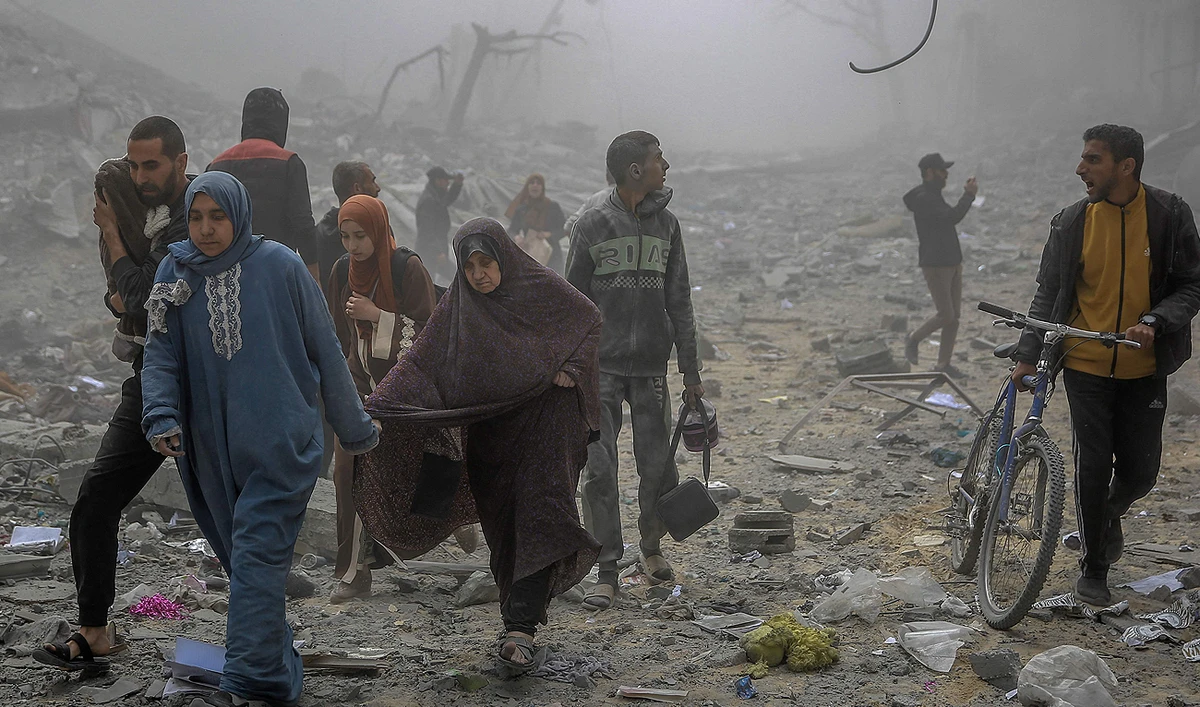 Palestinians flee the area after Israeli bombardment in central Gaza City on March 18, 2024, amid the ongoing battles between Israel and the Palestinian group Hamas. (AFP/File)