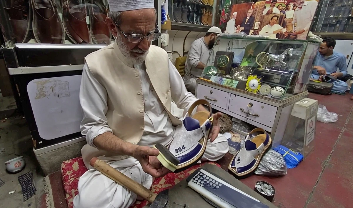 Noor-ud-Din, shoemaker, shows Qaidi, or Prisoner, No. 804 Chappal, in Peshawar, Pakistan on April 7, 2024. (AN photo)