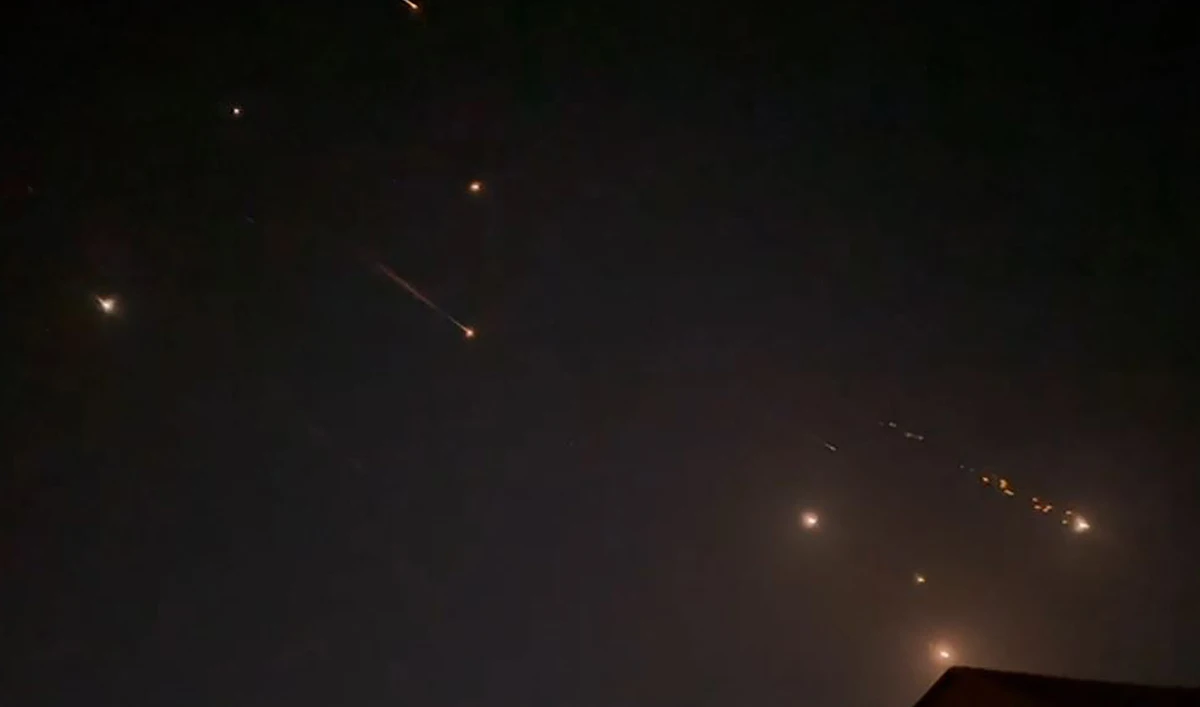 This video grab from AFPTV taken on April 14, 2024 shows explosions lighting up the sky in Hebron in the Israeli-occupied West Bank during an Iranian attack on Israel. (AFP)