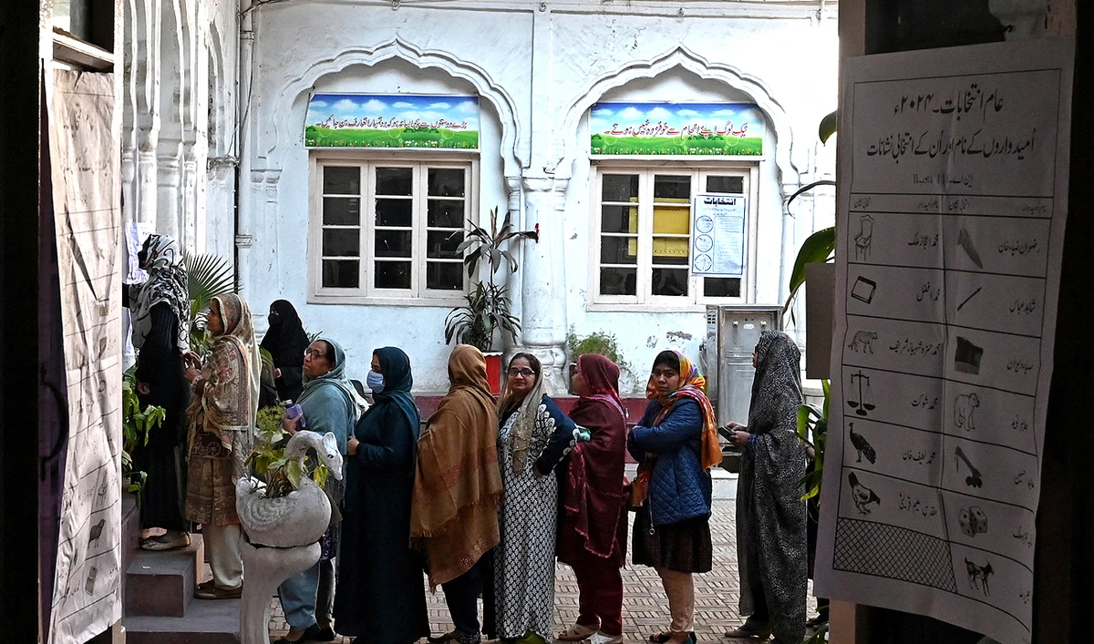 Pakistan’s women wait in a queue to cast their ballots to vote at a polling station during national elections in Lahore on February 8, 2024. (AFP/File)