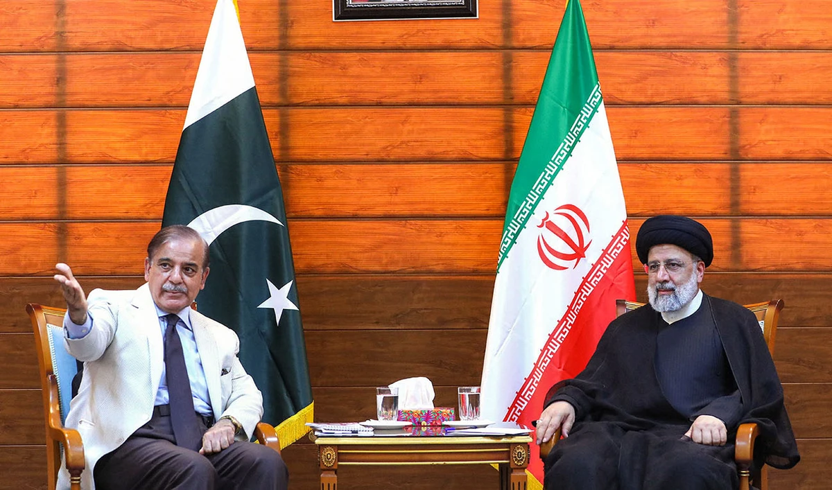 A handout picture provided by the Iranian presidency shows Iran's President Ebrahim Raisi (R) and Pakistan's Prime Minister Shahbaz Sharif meeting after a ceremony to inaugurate a new border market in the border city in Iran's southeastern border city of Pishin on May 18, 2023. (AFP/File)