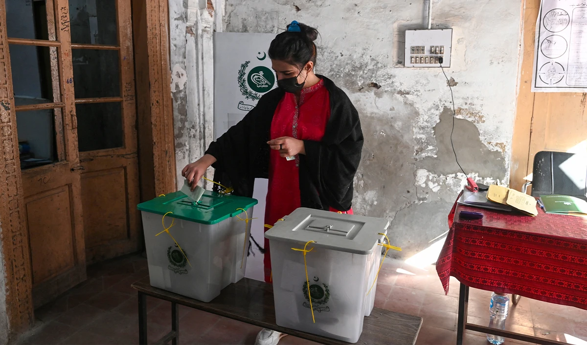 A woman casts her ballot to vote at a polling station during national elections in Lahore on February 8, 2024. (AFP/File)