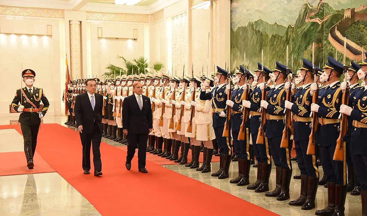This handout picture taken and released by the Pakistan Prime Minister Office on November 2, 2022, shows Pakistan Prime Minister Shahbaz Sharif (C) inspecting the guard of honour on his arrival at Great Hall of the People, ahead of his meeting with Chinese Premier Li Keqiang (2L) in Beijing, China. (AFP/File)
