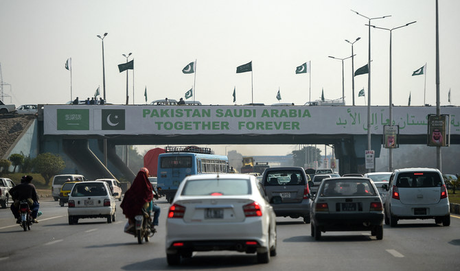 Pakistani commuters drive their vehicles under a banner welcoming Saudi Arabian Crown Prince Mohammed bin Salman displayed on a bridge, ahead of his arrival, in Islamabad on February 15, 2019. (AFP/File)