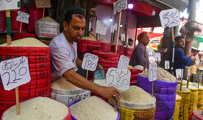 Shopkeepers sell cereals at a wholesale market in Karachi on June 8, 2023. (AFP/File)