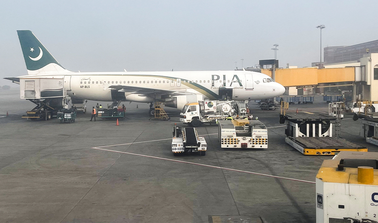 View of a Pakistan International Airlines (PIA) passengers plane, taken through a glass panel, at the Allama Iqbal International Airpor in Lahore, Pakistan on January 29, 2024. (REUTERS)