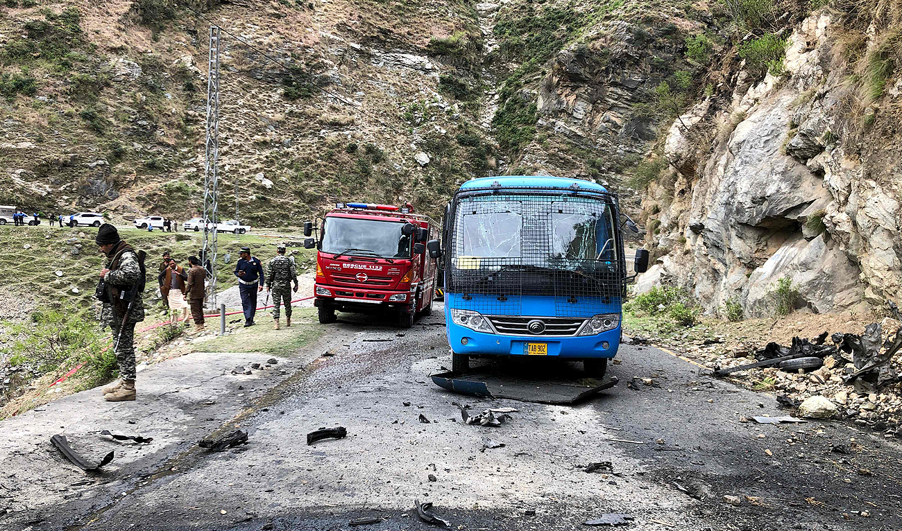 Security personnel inspect the site of a suicide attack near Besham city in the Shangla district of Khyber Pakhtunkhwa province on March 26, 2024. (AFP/File)