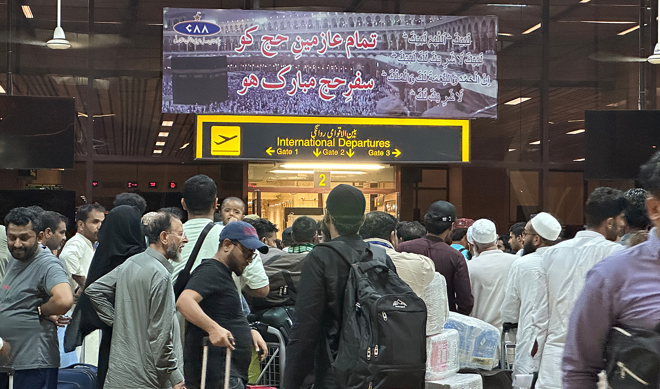 Pakistani Hajj pilgrims wait to check-in at an airport terminal for the first Hajj flight to Saudi Arabia, in Karachi on early May 9, 2024. This first Hajj flight marks the beginning of Makkah Route Initiative at Karachi airport. (AN Photo)