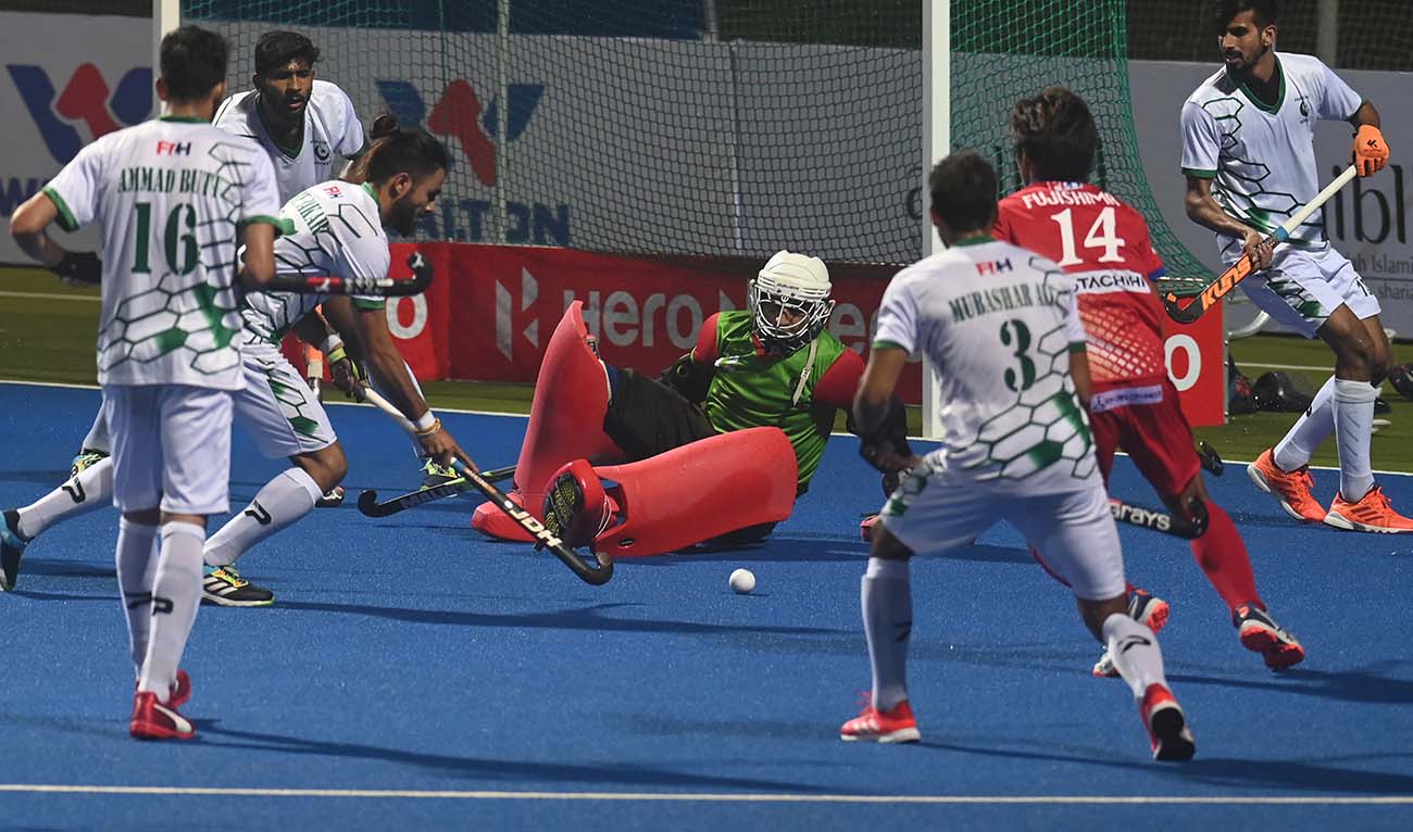 Pakistan's goal keeper Ali Amjad (C) tries to save a goal during the men's field hockey match between Pakistan and Japan at the Asian Championship Trophy tournament at the Maulana Bhashani National Hockey Stadium in Dhaka on December 14, 2021. (AFP/File)