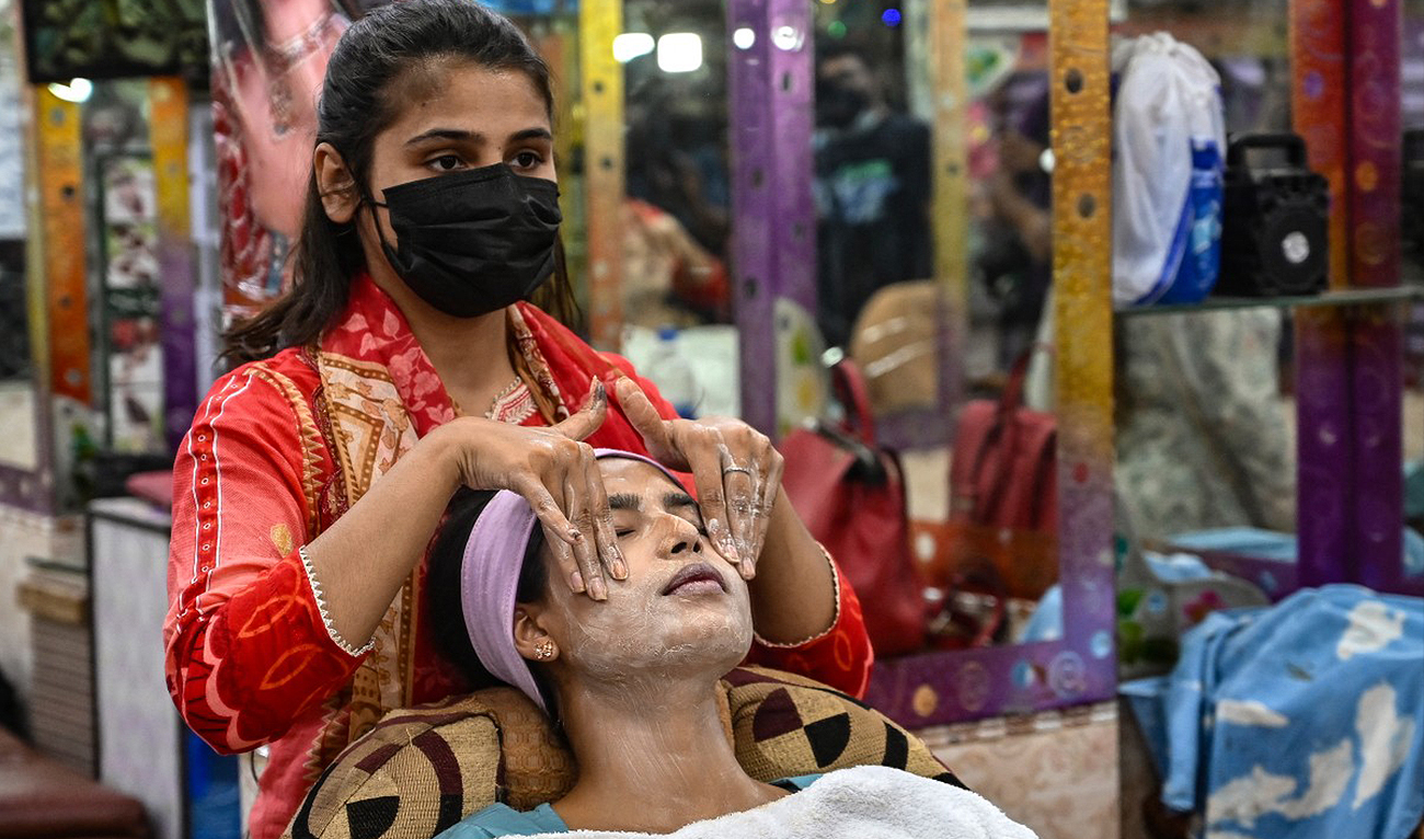 In this file photograph, taken on April 8, 2024, during Eid preparations, a customer gets a facial at a beauty salon in Karachi. (AFP/File)