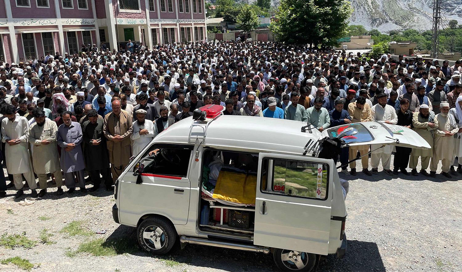 Kashmiri demonstrators of Awami Action Committee, offer funeral prayers for a victim a day after a clash with security force in Muzaffarabad, the capital of Pakistan-administered Kashmir on May 14, 2024. (AFP)