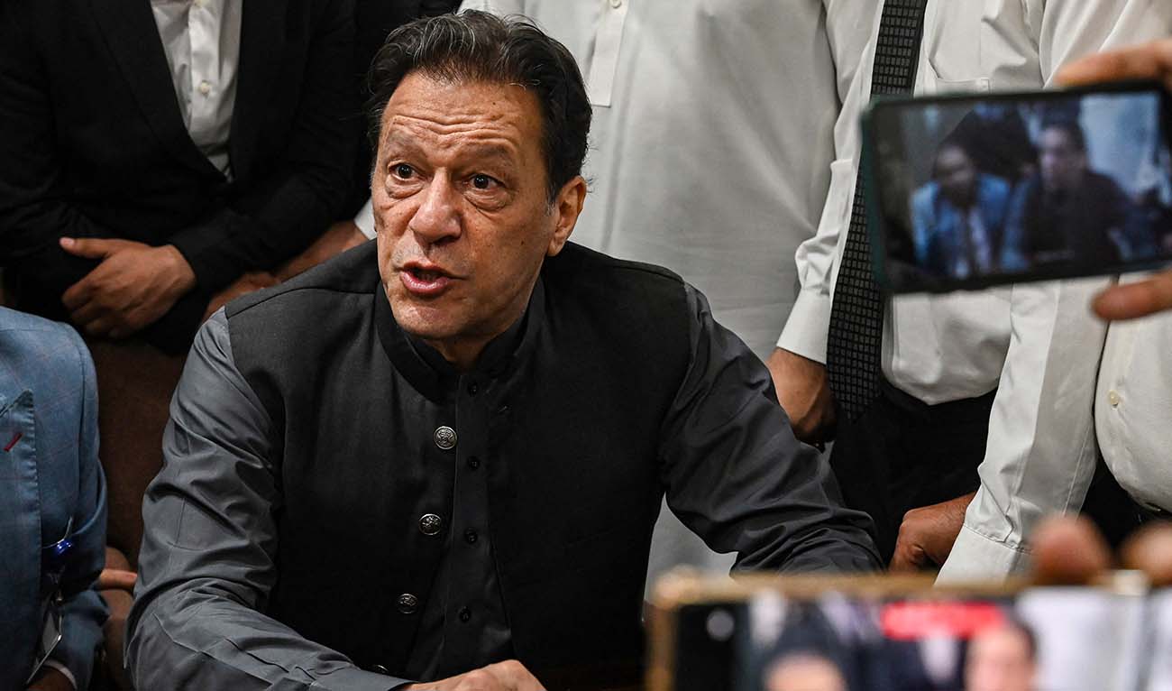 Pakistan's former prime minister, Imran Khan gestures after arriving at a registrar office in Lahore High court to sign surety bonds for bail in various cases, in Lahore on July 3, 2023. (AFP/File)
