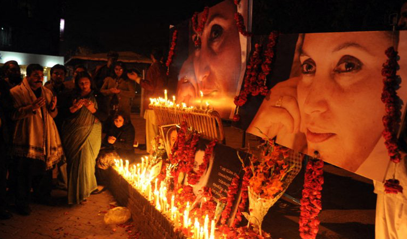 In this file photograph, taken on December 27, 2010, Pakistani human rights activists pray for former prime minister Benazir Bhutto on the third anniversary of her death in Islamabad. Bhutto was assassinated in a gun and suicide attack after addressing an election campaign rally in the garrison city of Rawalpindi on December 27, 2007. (AFP/File)