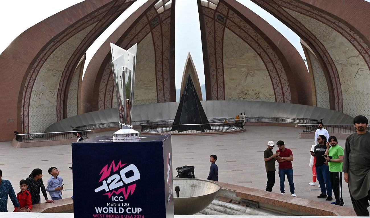 People gather around the trophy of upcoming ICC Men’s T20 World Cup 2024 during the trophy tour at the Pakistan Monument in Islamabad on April 25, 2024. The 2024 tournament will be hosted by the West Indies and the US from June 1 to 29, 2024. (AFP)