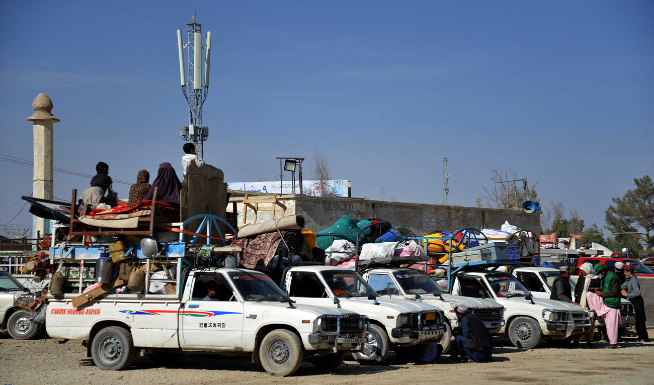 Afghan refugees with their belongings loaded on vehicles gather outside a registration centre upon arriving from Pakistan near the Afghanistan-Pakistan border in Spin Boldak district of Kandahar province on November 28, 2023. (AFP)