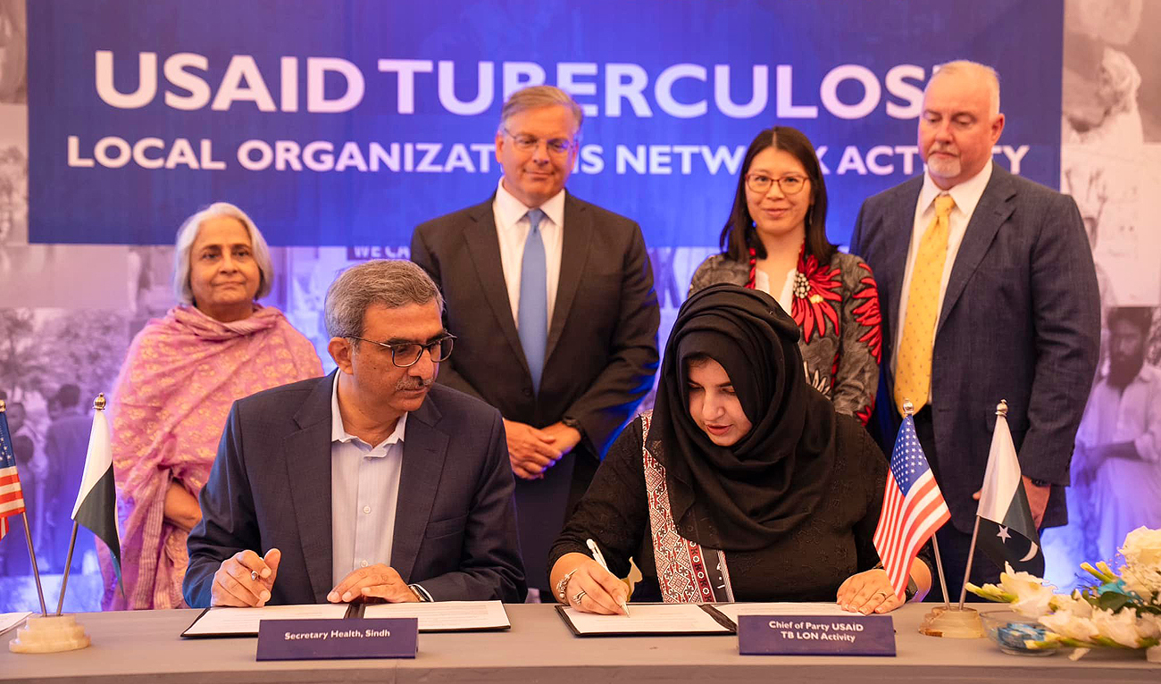 In this handout photograph, taken and released by US Embassy in Pakistan, official sign agreement as US Ambassador to Pakistan Donald Blome and Sindh Minister for Health and Population Dr. Azra Fazal Pechuho launched a collaborative initiative in Karachi on May 23, 2024, aimed at addressing tuberculosis, a significant health challenge in Pakistan. (Photo courtesy: US embassy)