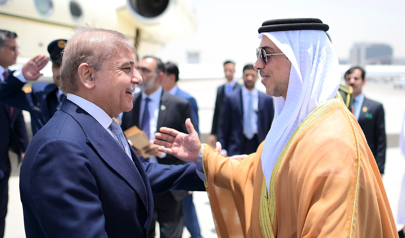 In this handout photograph, taken and released by Government of Pakistan, United Arab Emirates Vice President Sheikh Mansour bin Zayed Al Nahyan (right) receives Pakistan Prime Minister Shehbaz Sharif upon his arrival in Abu Dhabi om May 23, 2024. (Photo courtesy: PMO)