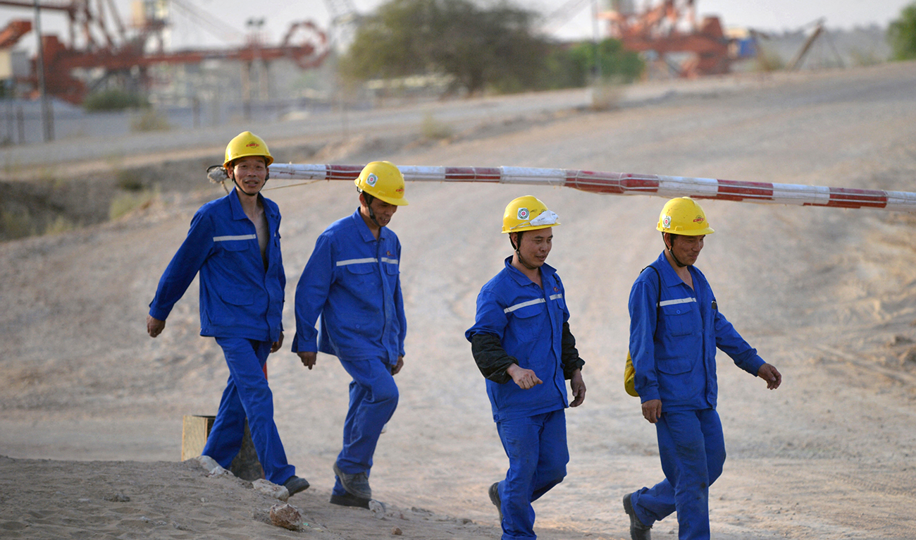 This picture taken on May 23, 2018 shows Chinese workers walking in a Chinese-backed power plant under construction in Islamkot in the desert in the Tharparkar district of Pakistan's southern Sindh province. (AFP/File)