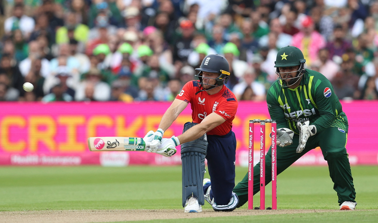 England’s Jos Buttler plays shot as Pakistan’s Azam Khan (right) watches ball during second T20 International between England and Pakistan at the Edgbaston Cricket Ground in Birmingham on May 25, 2024 (Reuters)