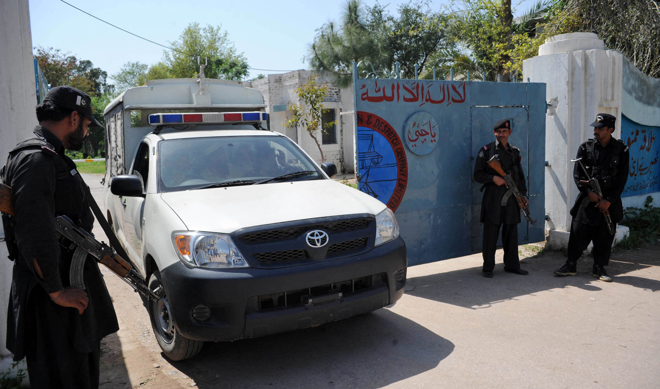 In this file photograph, taken on April 2, 2013, Pakistani security personnel stand guard outside an electricity power plant in Badh Bher, a suburb of Peshawar. (AFP/File)