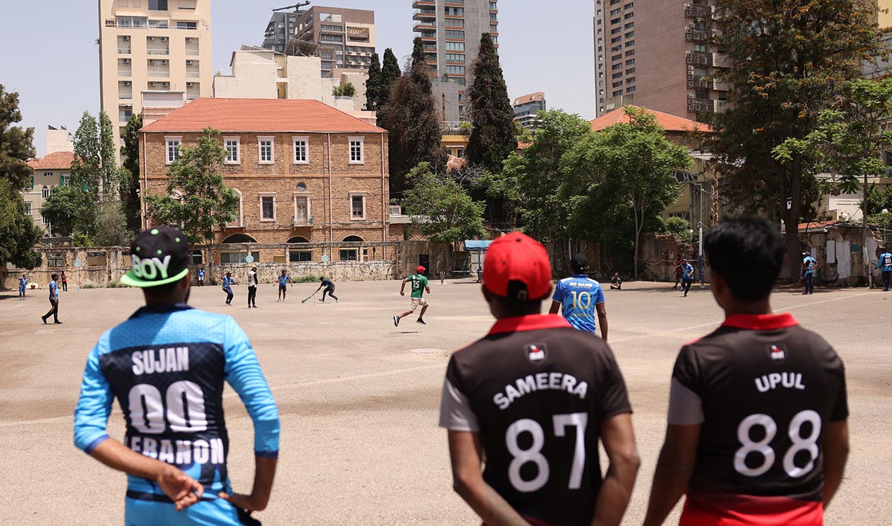 Migrants living in Lebanon take part in a cricket match held at a parking lot in Beirut on May 19, 2024. (AFP)