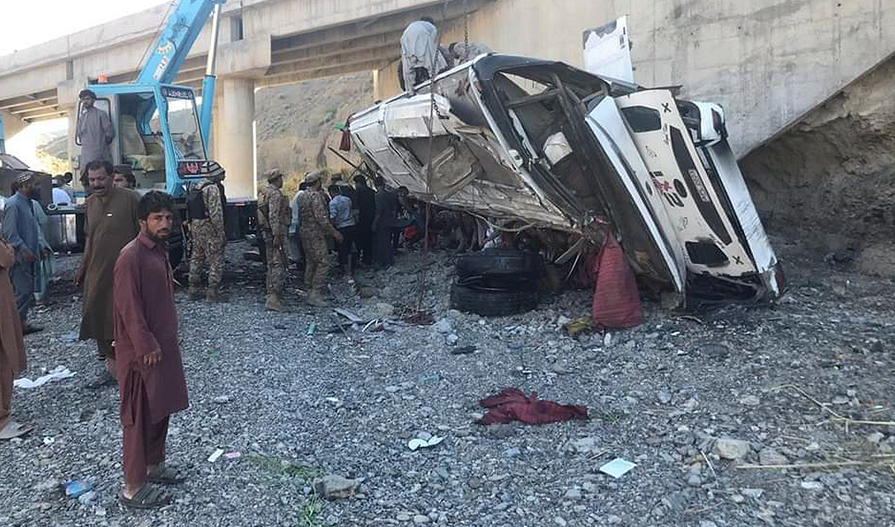 Pakistan military personnel and rescue workers stand in front of the accident site after a passenger bus crash in southwestern Balochistan province on May 29, 2024. (Photo courtesy: X/@zarrar_11PK)