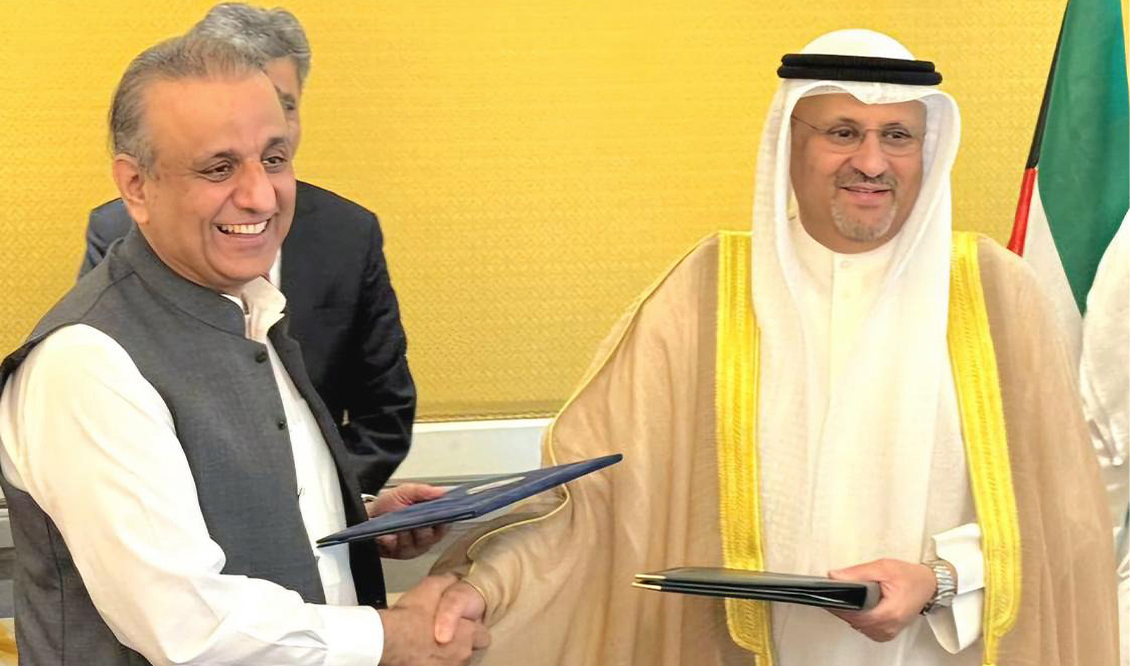 Pakistan’s Minister of Communications, Investment Board and Privatization Abdul Aleem Khan and Kuwait’s Minister of Commerce and Industry Omar Saud Al-Omar shake hands after signing agreements on industrial cooperation and engineering in Kuwait on May 30, 2024. (Government of Pakistan)
