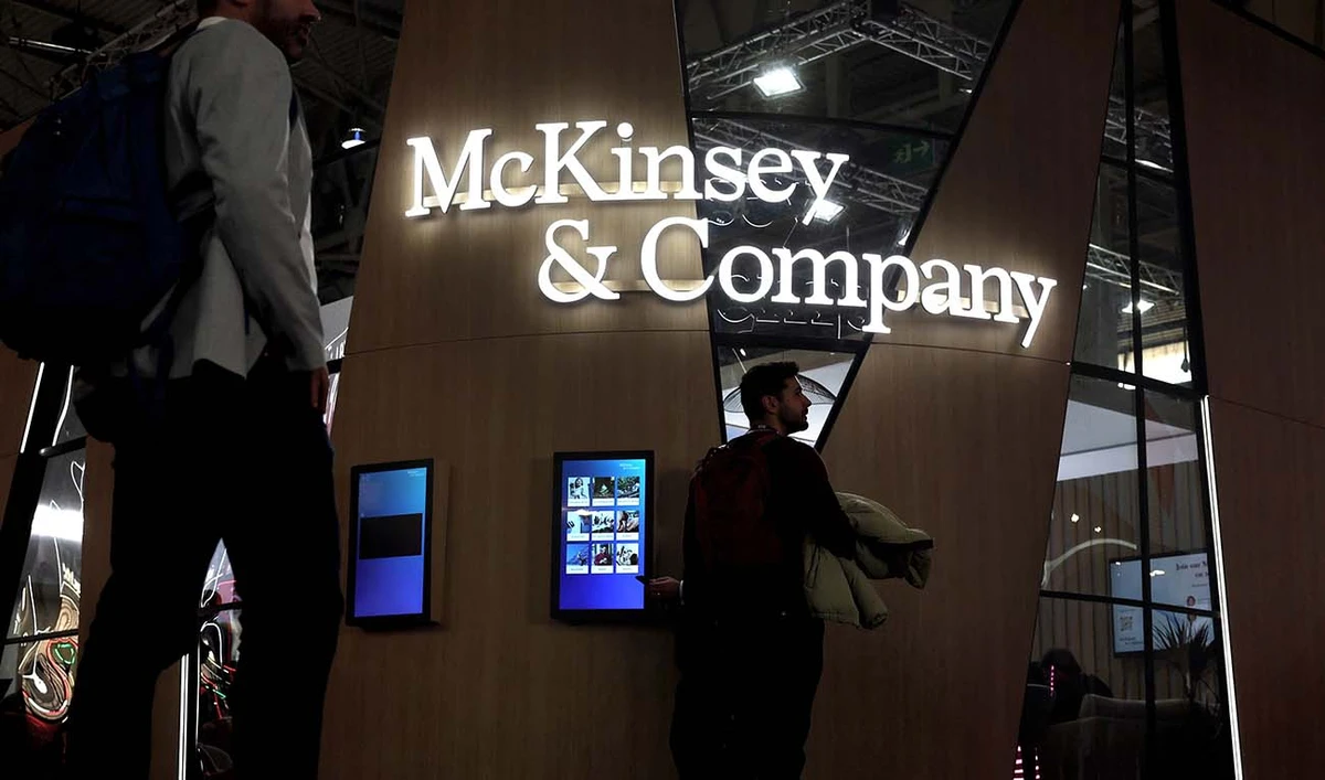 Visitors walk past the US global management consulting firm, McKinsey & Company, at the Mobile World Congress (MWC), the telecom industry's biggest annual gathering, in Barcelona on February 28, 2023. (AFP/File)