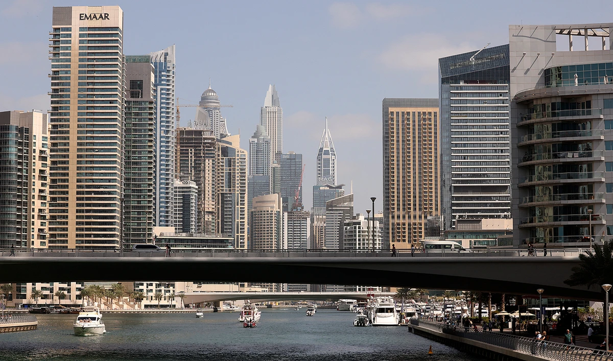 Boats sail along the Dubai Creek surrounded by high-rise buildings in the Gulf emirate, on February 18, 2023. (AFP/File)