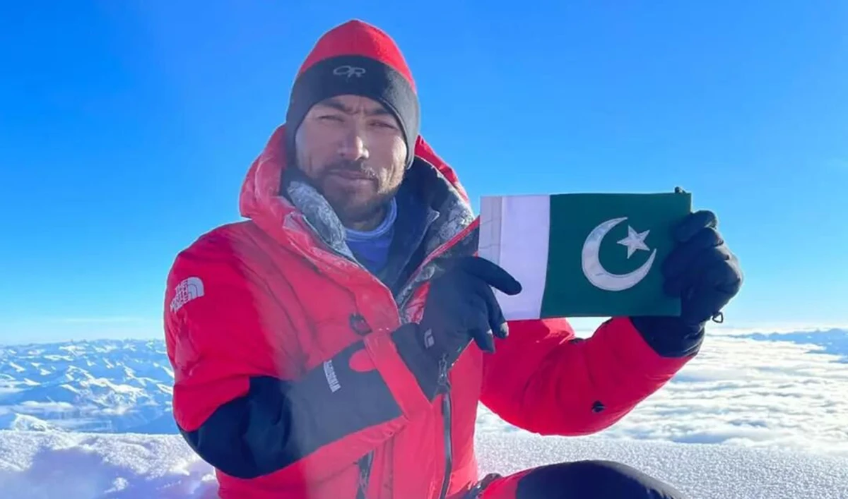 The file photo shows Pakistani mountaineer Sirbaz Khan poses with a Pakistani flag at the top of Mt. Dhaulagiri in Nepal. (Photo courtesy: Sirbaz_Mission14/Instagram)