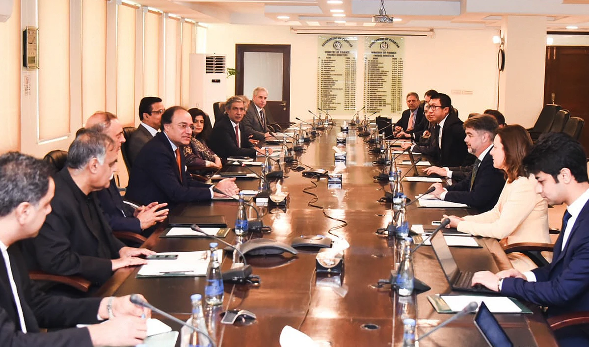 This handout photograph released by the Pakistan’s Ministry of Finance on May 13, 2024, shows Pakistan’s Finance Minister Muhammad Aurangzeb (L) meeting with a International Monetary Fund (IMF) review mission led by IMF mission official Nathan Porter (2R) at the Finance Ministry in Islamabad. (Photo courtesy: Ministry of Finance)