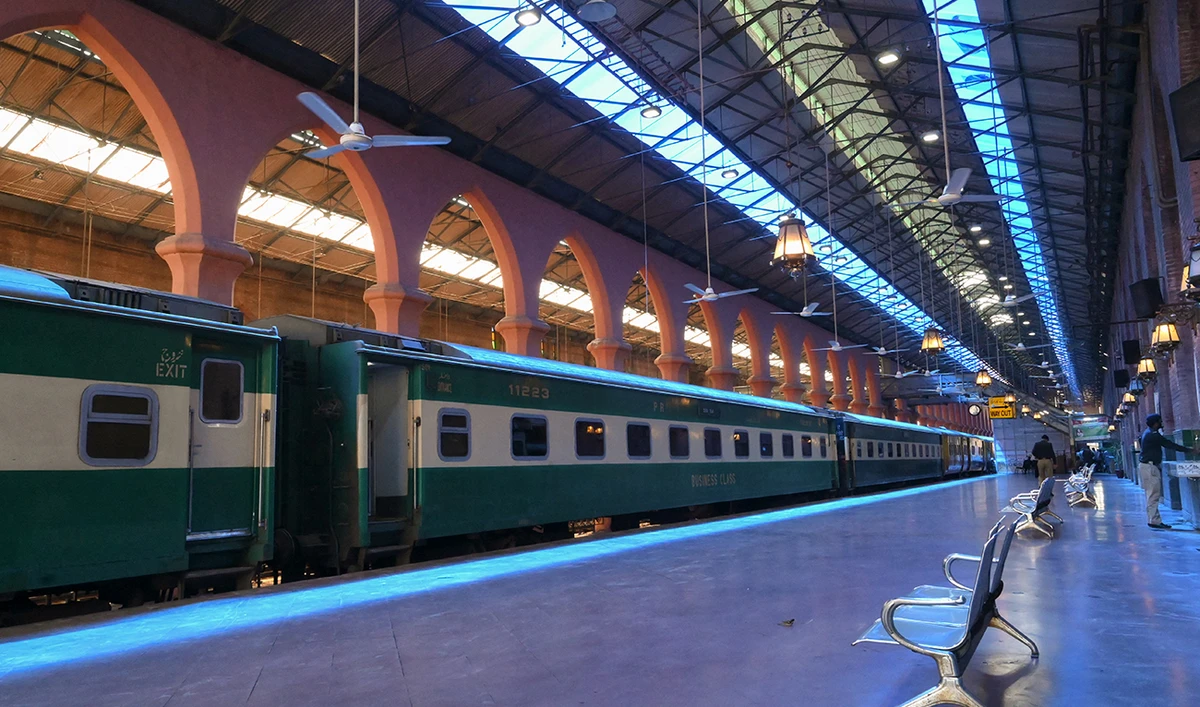 A Pakistani policeman (R) washes his hands on a deserted Lahore railway station during a government-imposed nationwide lockdown as a preventive measure against the COVID-19 coronavirus, in Lahore on April 19, 2020. (AFP/File)
