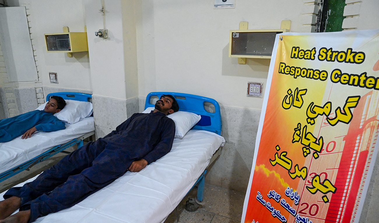 In this picture taken on May 11, 2022, patients suffering from heat stroke are treated at a hospital in Jacobabad, in the southern Sindh province. (AFP/File)