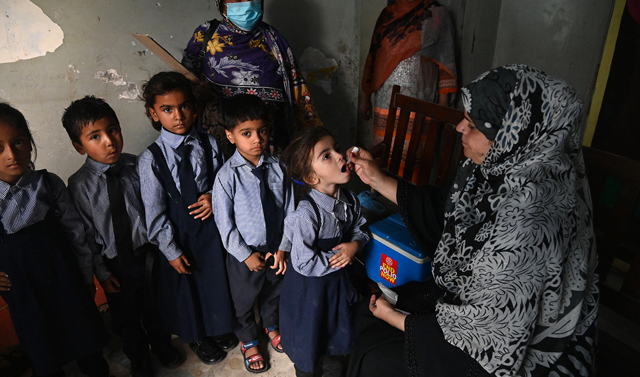 A health worker administers polio vaccine drops to a child during a vaccination campaign in Lahore on October 24, 2022. (AFP/File)