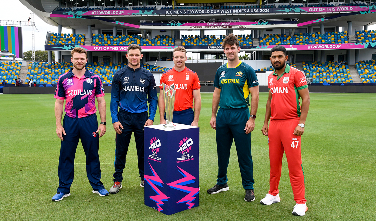 Richie Berrington (L) of Scotland, Gerhard Erasmus (2L) of Namibia, Jos Buttler (C) of England, Mitchell Marsh (2R) and Aqib Ilyas (R) of Oman with the trophy ahead of the start of the ICC Men's T20 CWC at Kensington Oval, Bridgetown, Barbados, on June 1, 2024. (AFP)