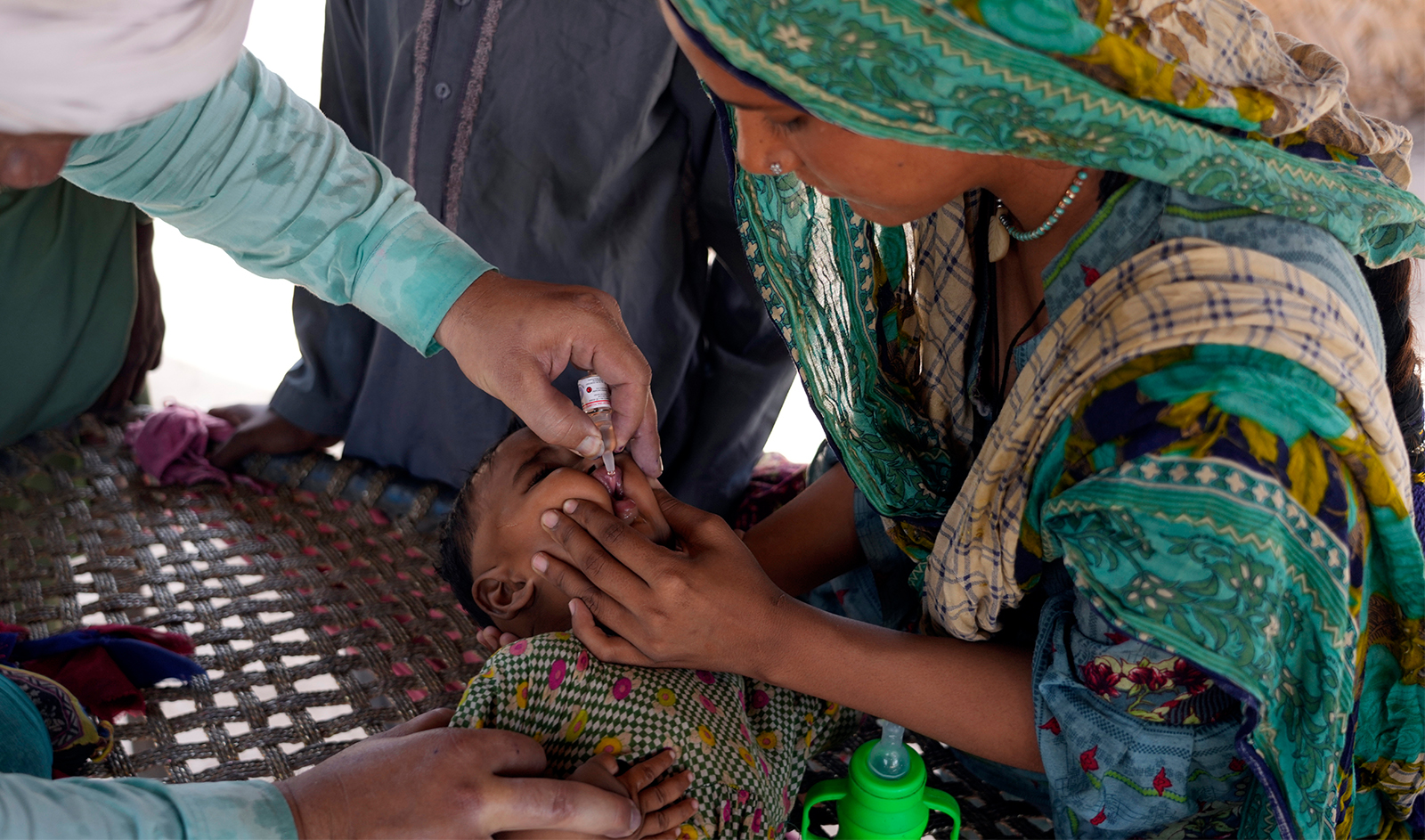 A health worker administers a polio vaccine to a child in a neighborhood of Lahore, Pakistan, on June 3, 2024. (AP)