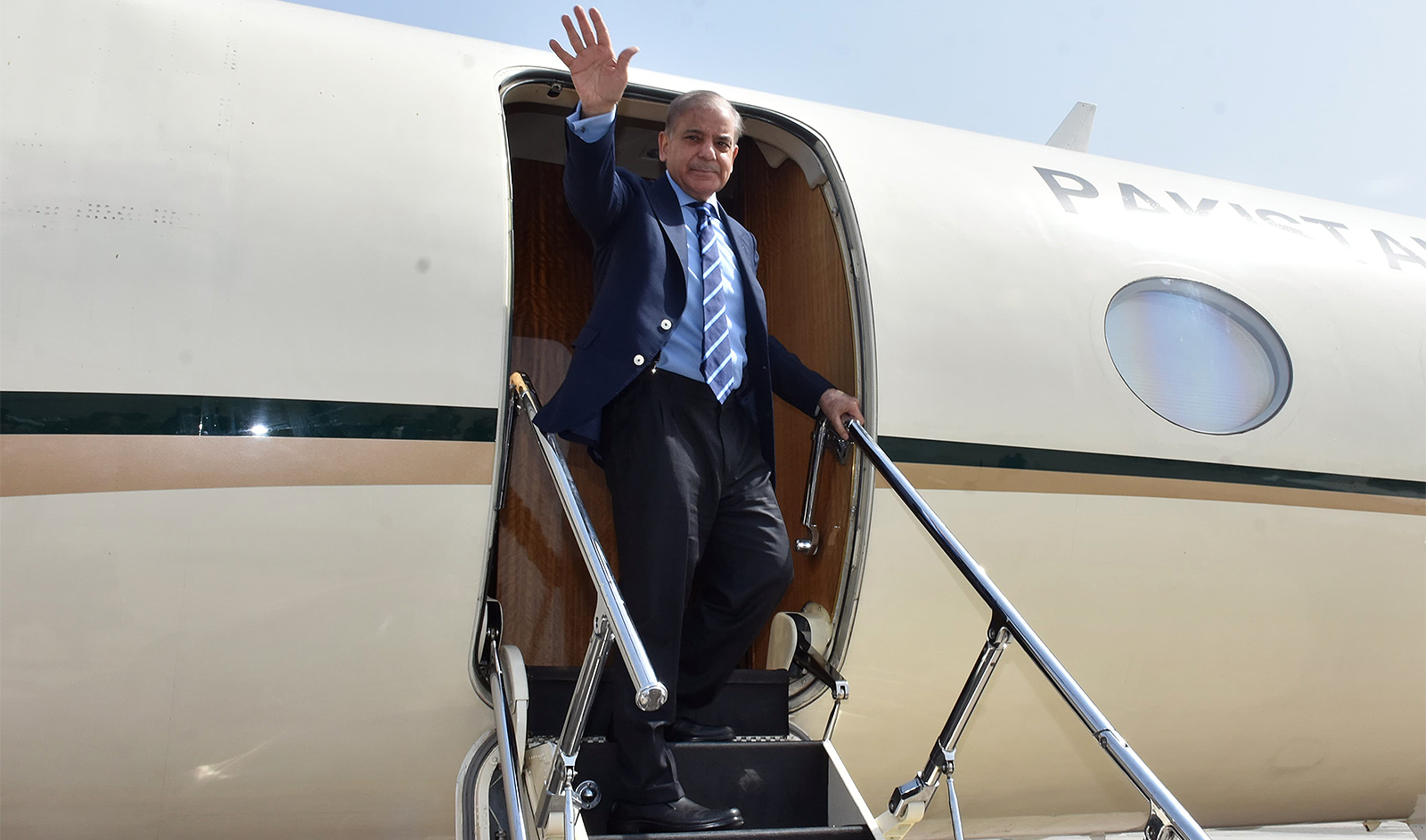 Pakistan Prime Minister Shehbaz Sharif waves as he embarks on a plane to leave for China in Rawalpindi, Pakistan on June 4, 2024. (Government of Pakistan)