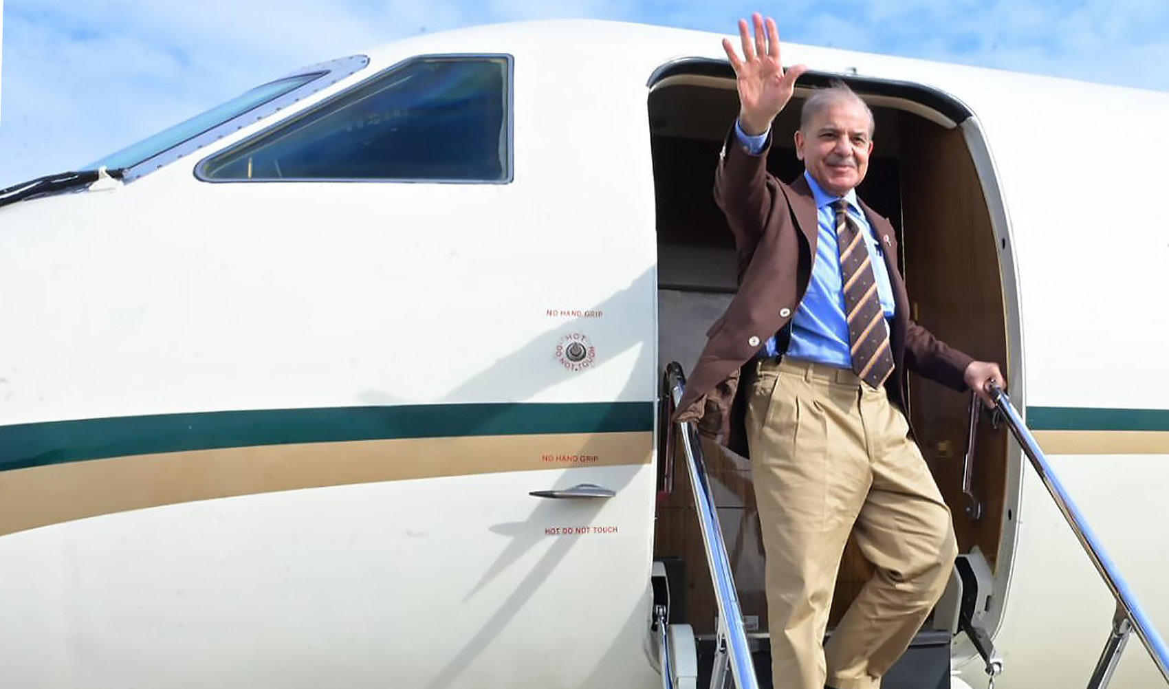 Prime Minister Shehbaz Sharif waves as he embarks on a plane to return to Pakistan in the northwestern Chinese city of Xi’an on June 8, 2024. (Government of Pakistan)