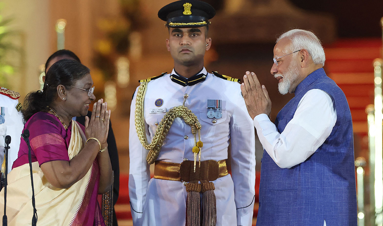 In this handout photograph taken on June 9, 2024 and released by the Indian Press Information Bureau (PIB) Bharatiya Janata Party (BJP) leader Narendra Modi (R) greets India’s President Droupadi Murmu (L) before being sworn-in as the country’s Prime Minister for a third term during the oath-taking ceremony at presidential palace Rashtrapati Bhavan in New Delhi on June 9, 2024. (AFP)